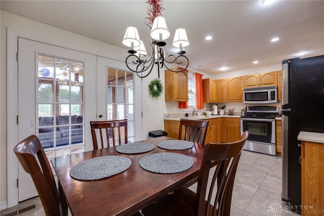 1817 El Camino Dr, Xenia, OH 45385 - dining room featuring a chandelier, plenty of natural light, light tile patterned floors, and recessed lighting