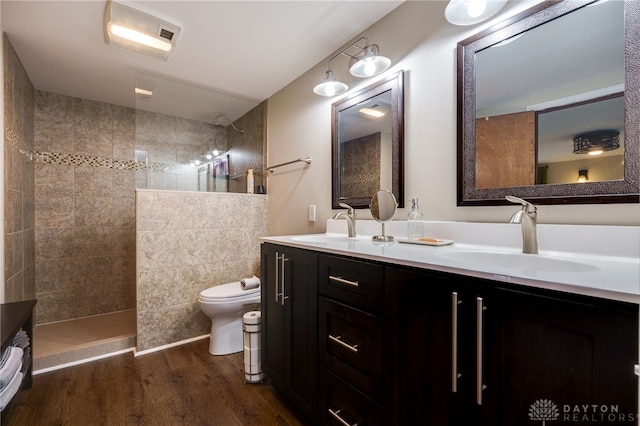1817 El Camino Dr, Xenia, OH 45385 - bathroom featuring a walk in shower, double vanity, and wood finished floors