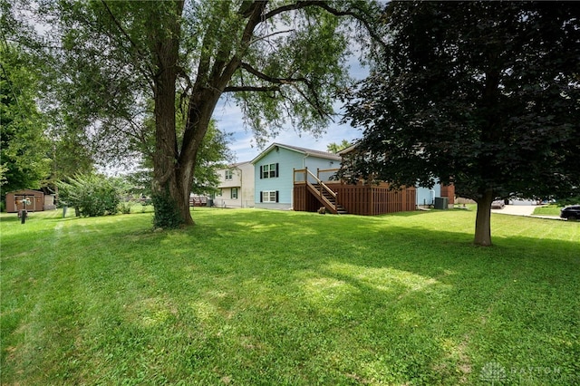 1817 El Camino Dr, Xenia, OH 45385 - view of green lawn featuring stairway, a deck, and a storage unit