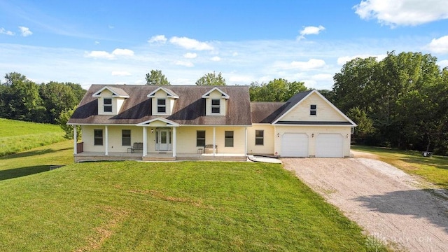 7373 Crowl Rd, Degraff, OH 43318 - new england style home featuring covered porch, driveway, an attached garage, and a front yard