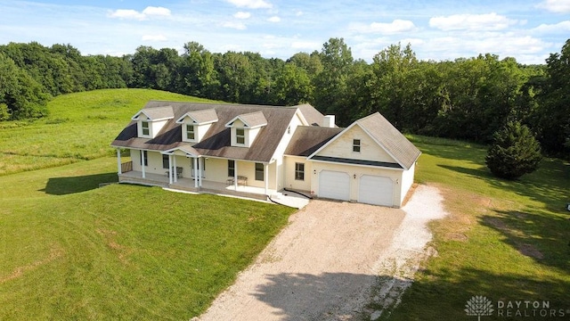 7373 Crowl Rd, Degraff, OH 43318 - cape cod house with a porch, driveway, a garage, and a front yard