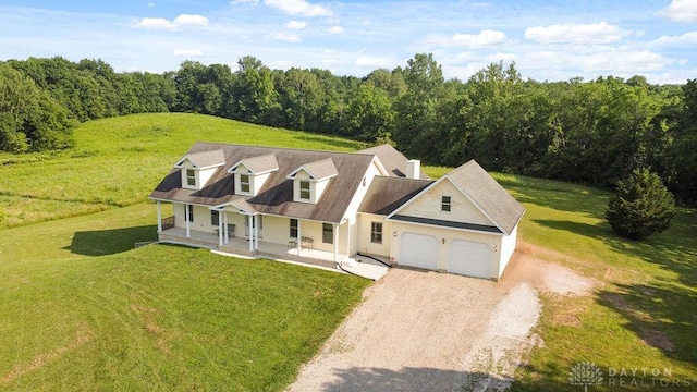 7373 Crowl Rd, Degraff, OH 43318 - view of front of home featuring a porch, dirt driveway, a garage, and a front yard