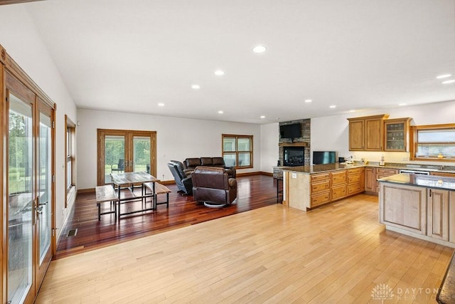 7373 Crowl Rd, Degraff, OH 43318 - kitchen with open floor plan, light wood-style floors, recessed lighting, a peninsula, and glass insert cabinets
