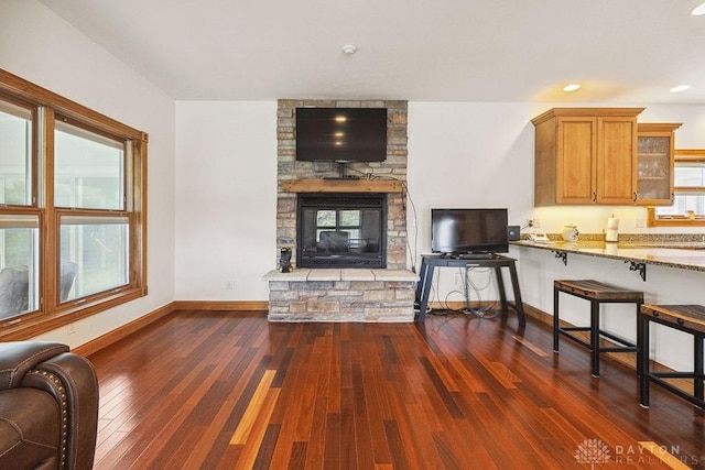 7373 Crowl Rd, Degraff, OH 43318 - living room with dark wood finished floors, a fireplace, and recessed lighting