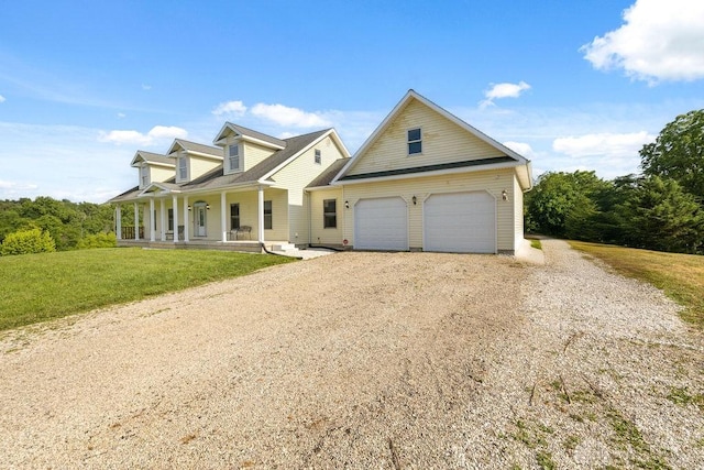 7373 Crowl Rd, Degraff, OH 43318 - view of front facade featuring covered porch, driveway, a garage, and a front yard