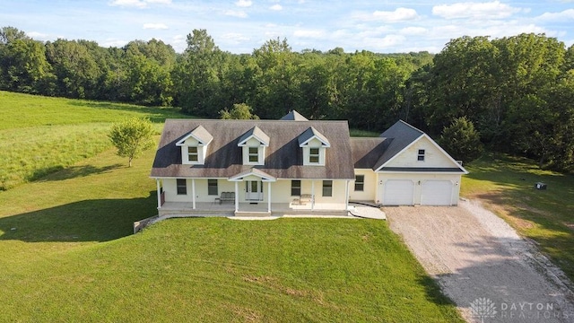 7373 Crowl Rd, Degraff, OH 43318 - cape cod home with covered porch, dirt driveway, a garage, and a front yard