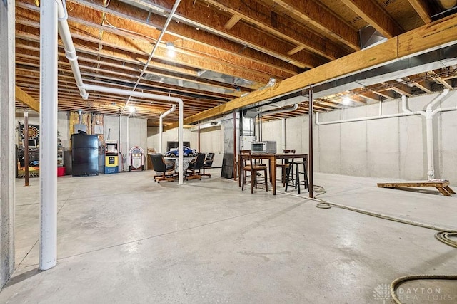 7373 Crowl Rd, Degraff, OH 43318 - unfinished below grade area with freestanding refrigerator