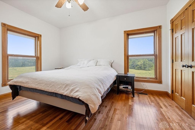 7373 Crowl Rd, Degraff, OH 43318 - bedroom with hardwood / wood-style floors, multiple windows, and ceiling fan