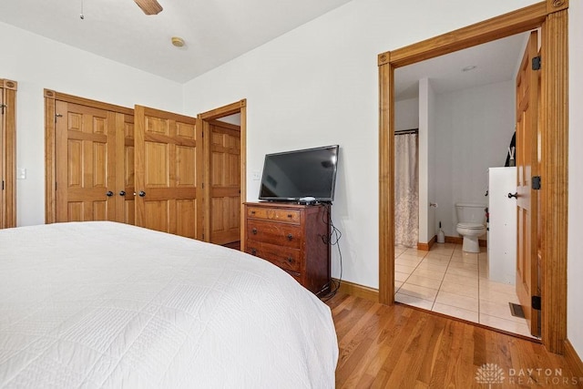 7373 Crowl Rd, Degraff, OH 43318 - bedroom featuring light wood finished floors, connected bathroom, and ceiling fan