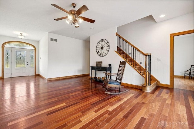 7373 Crowl Rd, Degraff, OH 43318 - foyer entrance featuring wood finished floors, a fireplace, stairway, and ceiling fan