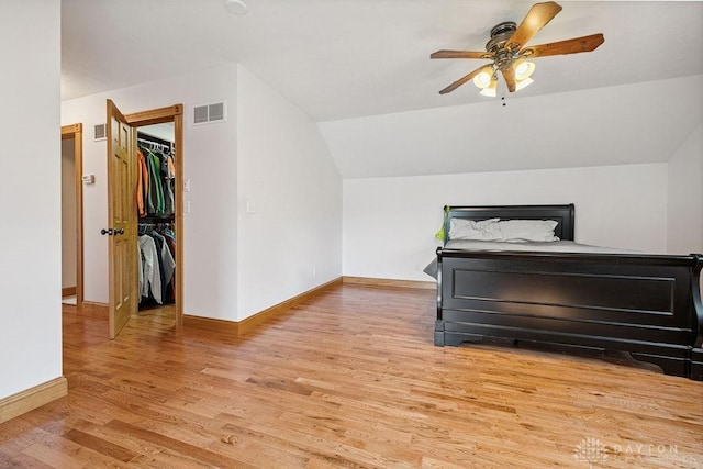 7373 Crowl Rd, Degraff, OH 43318 - bedroom with light wood finished floors, lofted ceiling, a spacious closet, and ceiling fan