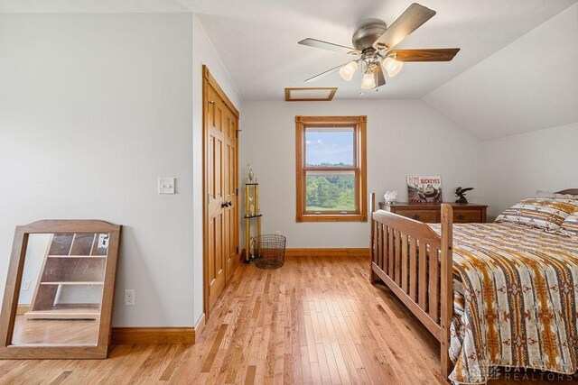 7373 Crowl Rd, Degraff, OH 43318 - bedroom with light wood-style flooring, vaulted ceiling, and a ceiling fan