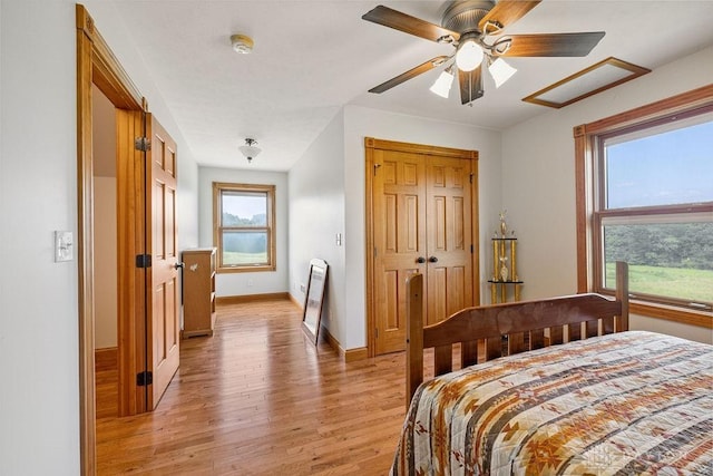 7373 Crowl Rd, Degraff, OH 43318 - bedroom with light wood finished floors, ceiling fan, and a closet
