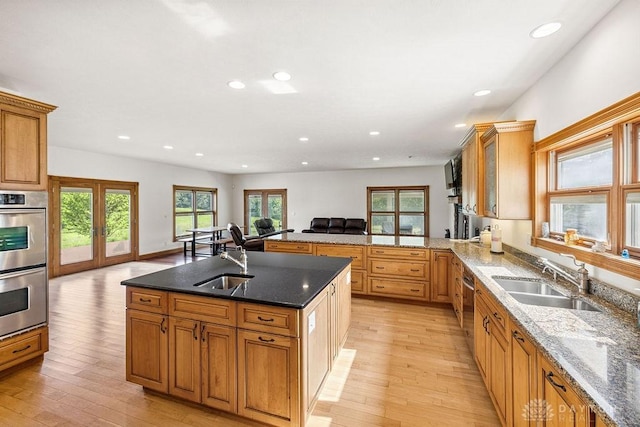 7373 Crowl Rd, Degraff, OH 43318 - kitchen with double oven, light wood-type flooring, recessed lighting, dark stone counters, and french doors