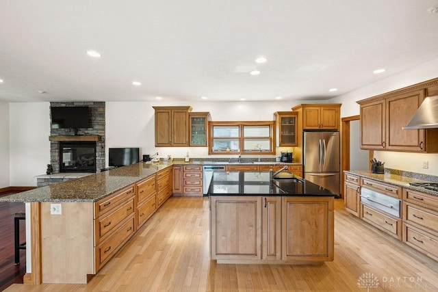 7373 Crowl Rd, Degraff, OH 43318 - kitchen with appliances with stainless steel finishes, a warming drawer, light wood-type flooring, a peninsula, and glass insert cabinets