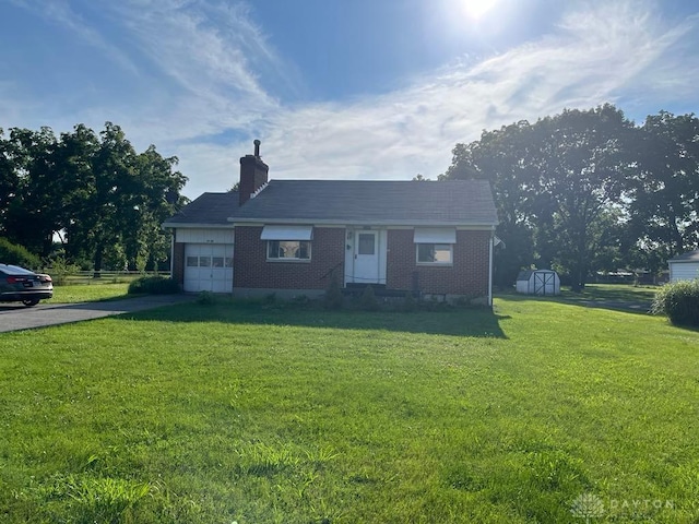 5747 N Springboro Pike, Dayton, OH 45449 - view of front of property with a storage shed, a garage, brick siding, and a front yard