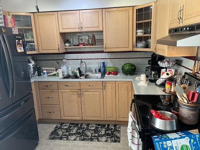 5747 N Springboro Pike, Dayton, OH 45449 - kitchen with freestanding refrigerator, stainless steel electric stove, light countertops, under cabinet range hood, and decorative backsplash