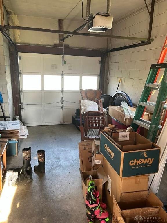 5747 N Springboro Pike, Dayton, OH 45449 - garage featuring a garage door opener and concrete block wall