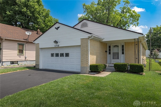 1716 Pershing Blvd, Dayton, OH 45420 - view of front of home featuring asphalt driveway, an attached garage, and brick siding