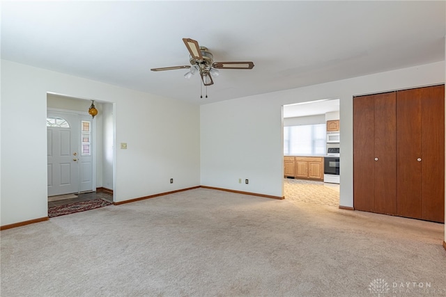 1716 Pershing Blvd, Dayton, OH 45420 - unfurnished living room with light carpet and a ceiling fan