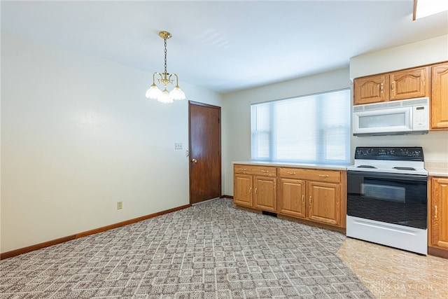 1716 Pershing Blvd, Dayton, OH 45420 - kitchen featuring white microwave, range with electric cooktop, a chandelier, light countertops, and hanging light fixtures