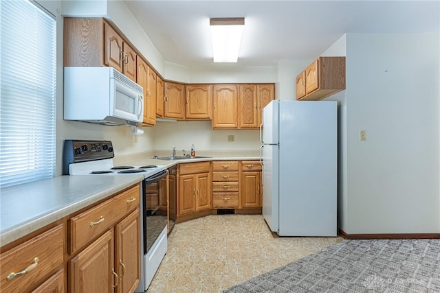 1716 Pershing Blvd, Dayton, OH 45420 - kitchen with white appliances, light countertops, and brown cabinets
