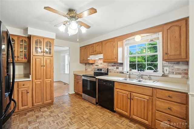 3811 Berryleaf Ct, Dayton, OH 45424 - kitchen with black appliances, under cabinet range hood, backsplash, light countertops, and ceiling fan