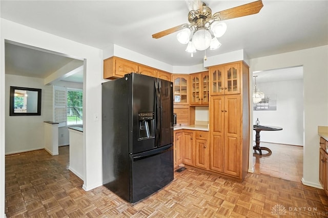 3811 Berryleaf Ct, Dayton, OH 45424 - kitchen featuring black refrigerator with ice dispenser, ceiling fan, glass insert cabinets, light countertops, and brown cabinetry