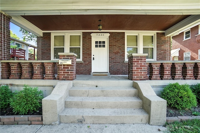 7336 Maple Ave, Cincinnati, OH 45231 - property entrance featuring a porch and brick siding