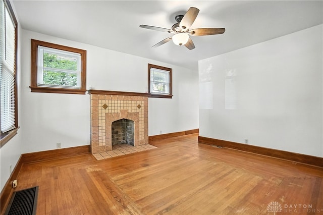 7336 Maple Ave, Cincinnati, OH 45231 - unfurnished living room with a ceiling fan, a fireplace, and wood finished floors