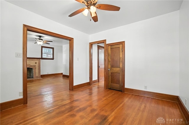 7336 Maple Ave, Cincinnati, OH 45231 - empty room featuring ceiling fan, wood finished floors, and a fireplace with flush hearth