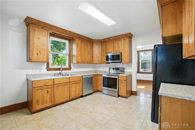 7336 Maple Ave, Cincinnati, OH 45231 - kitchen featuring appliances with stainless steel finishes, light countertops, and brown cabinetry
