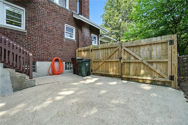 7336 Maple Ave, Cincinnati, OH 45231 - view of side of property featuring brick siding, a gate, and a patio area