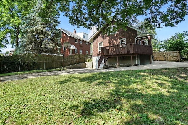 7336 Maple Ave, Cincinnati, OH 45231 - rear view of house featuring stairs, a wooden deck, brick siding, a gate, and a garage
