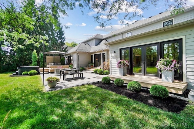 525 Heatherwoode Cir, Springboro, OH 45066 - back of property featuring a hot tub, french doors, an outdoor living space, a lawn, and a patio