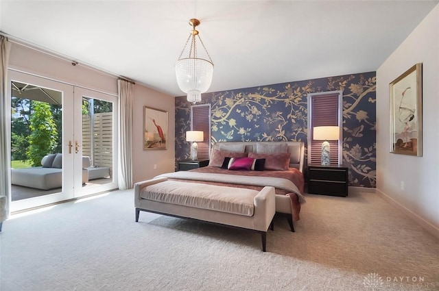 525 Heatherwoode Cir, Springboro, OH 45066 - bedroom with access to exterior, carpet floors, french doors, wallpapered walls, and a chandelier