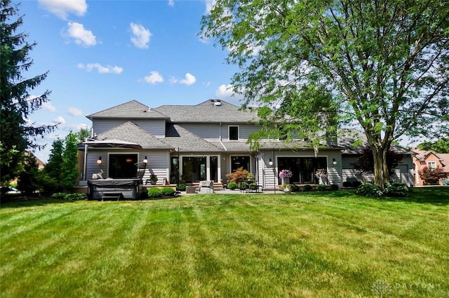525 Heatherwoode Cir, Springboro, OH 45066 - back of house featuring a hot tub, a yard, a patio area, and roof with shingles