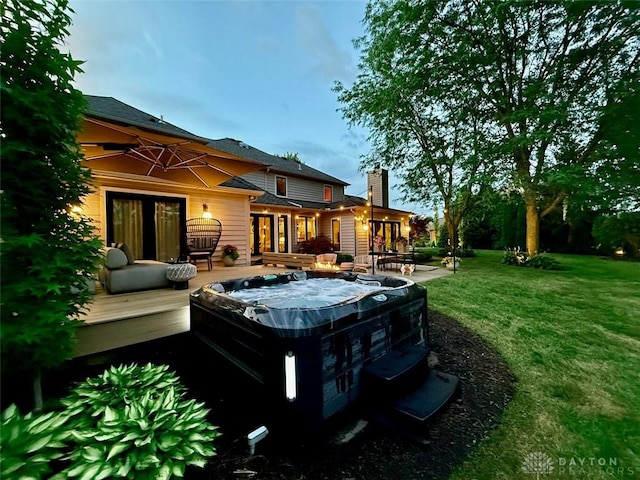 525 Heatherwoode Cir, Springboro, OH 45066 - back of property featuring a hot tub, a deck, a lawn, and a chimney