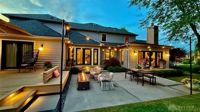 525 Heatherwoode Cir, Springboro, OH 45066 - rear view of house featuring a fire pit, french doors, a shingled roof, a patio area, and a chimney