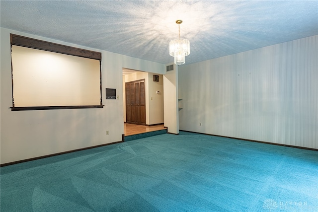 3072 Fowler Rd, Springfield, OH 45502 - empty room with a chandelier, carpet flooring, and a textured ceiling