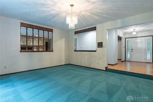 3072 Fowler Rd, Springfield, OH 45502 - carpeted empty room with a chandelier and a textured ceiling