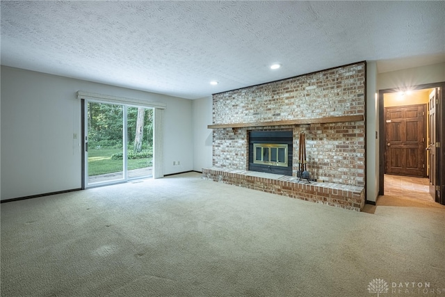 3072 Fowler Rd, Springfield, OH 45502 - unfurnished living room featuring carpet, a textured ceiling, a brick fireplace, and recessed lighting