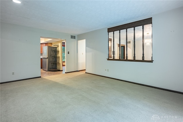 3072 Fowler Rd, Springfield, OH 45502 - spare room featuring light colored carpet, a textured ceiling, and recessed lighting