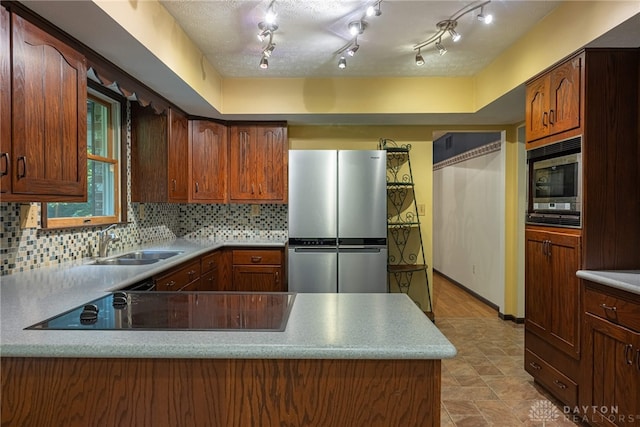 3072 Fowler Rd, Springfield, OH 45502 - kitchen with stainless steel appliances, decorative backsplash, light countertops, and a peninsula