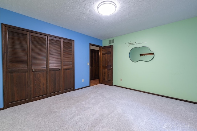 3072 Fowler Rd, Springfield, OH 45502 - unfurnished bedroom with carpet, a closet, and a textured ceiling