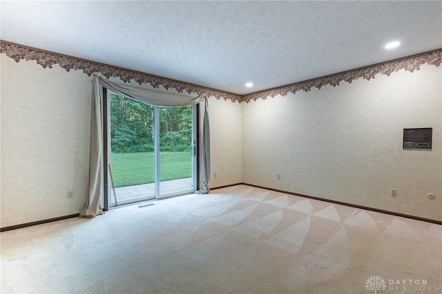 3072 Fowler Rd, Springfield, OH 45502 - unfurnished room featuring light colored carpet, a textured ceiling, and recessed lighting