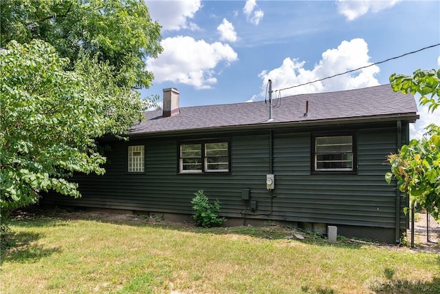 4651 Christopher Ave, Dayton, OH 45406 - view of side of home featuring a chimney, a lawn, and a shingled roof