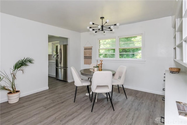 4651 Christopher Ave, Dayton, OH 45406 - dining space with a chandelier and wood finished floors