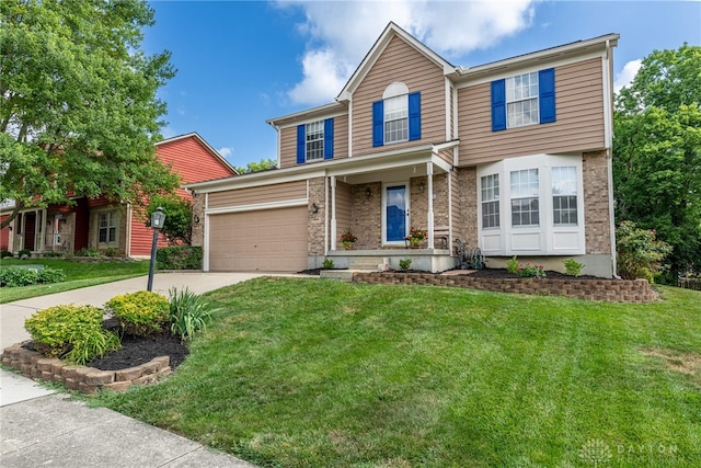 274 Tamarack Trl, Springboro, OH 45066 - traditional-style house with concrete driveway, a front yard, brick siding, and an attached garage