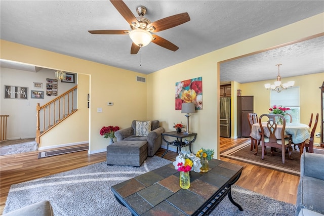 274 Tamarack Trl, Springboro, OH 45066 - living area featuring stairway, wood finished floors, ceiling fan, a chandelier, and a textured ceiling